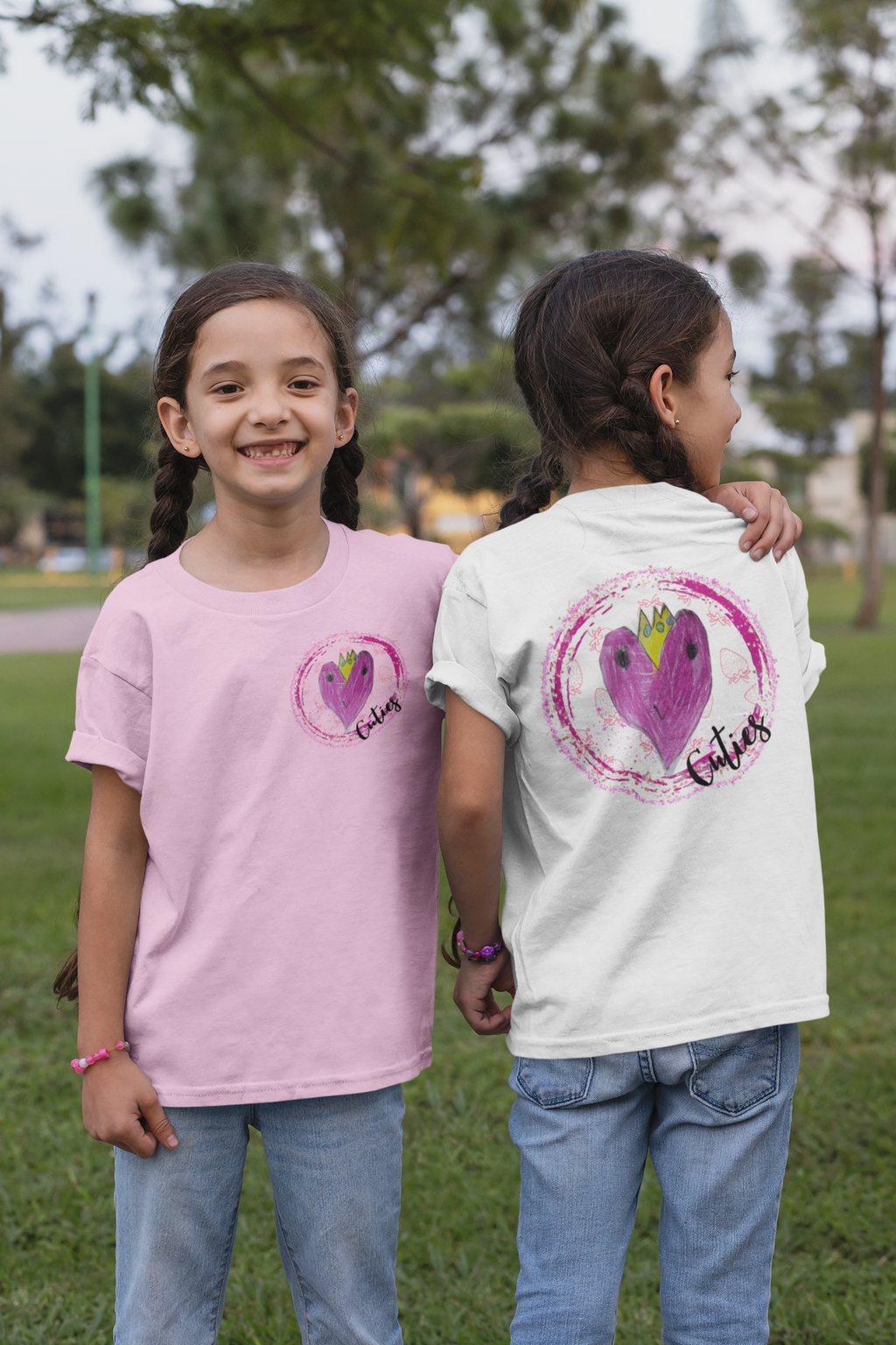 Two girls wearing pink and white Cuties graphic tees front and back – V's Designs kids streetwear by Spam Loves Rice