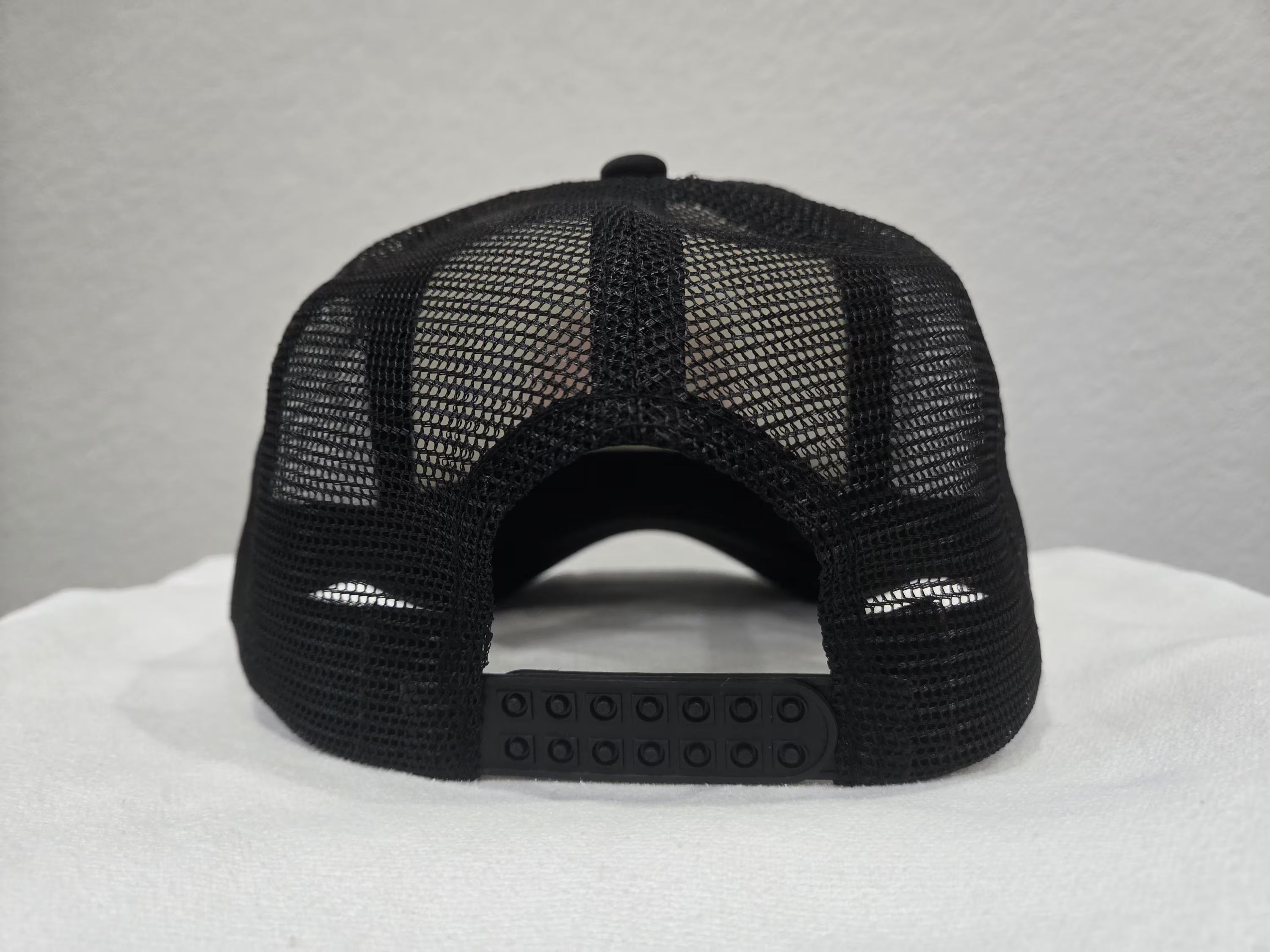 Back view of black curvebill trucker hat with mesh snapback - Rice and Revenge by Spam Loves Rice
