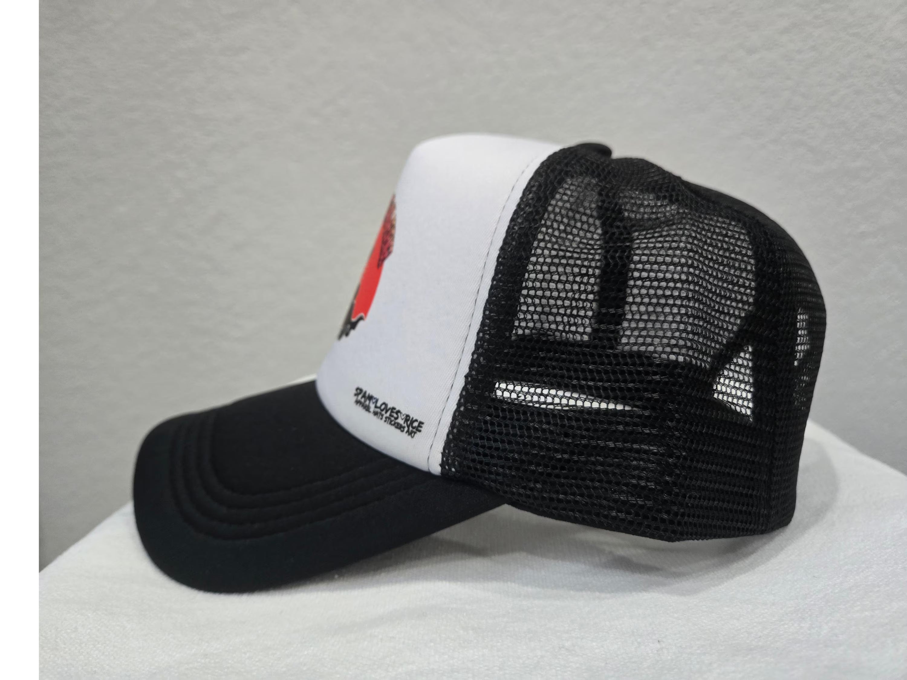 Side view of black and white Rice and Revenge curvebill trucker hat – Filipino streetwear by Spam Loves Rice